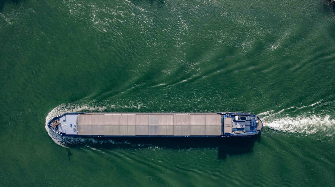 Aerial view of container ships transiting a narrow waterway.